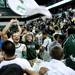 EMU senior Derek Thompson celebrates with fans after they rushed the court for defeating Purdue 47-44 on Saturday. Daniel Brenner I AnnArbor.com